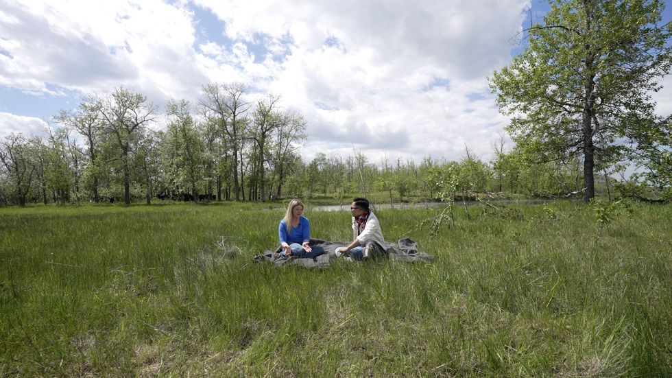 Two people sitting at Tapley Family Farm in Manitoba.