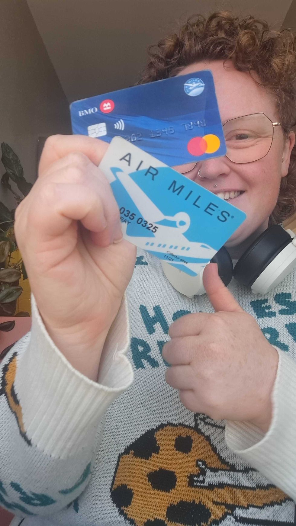 Louie Murray holding an AIR MILES collector card and BMO Mastercard.