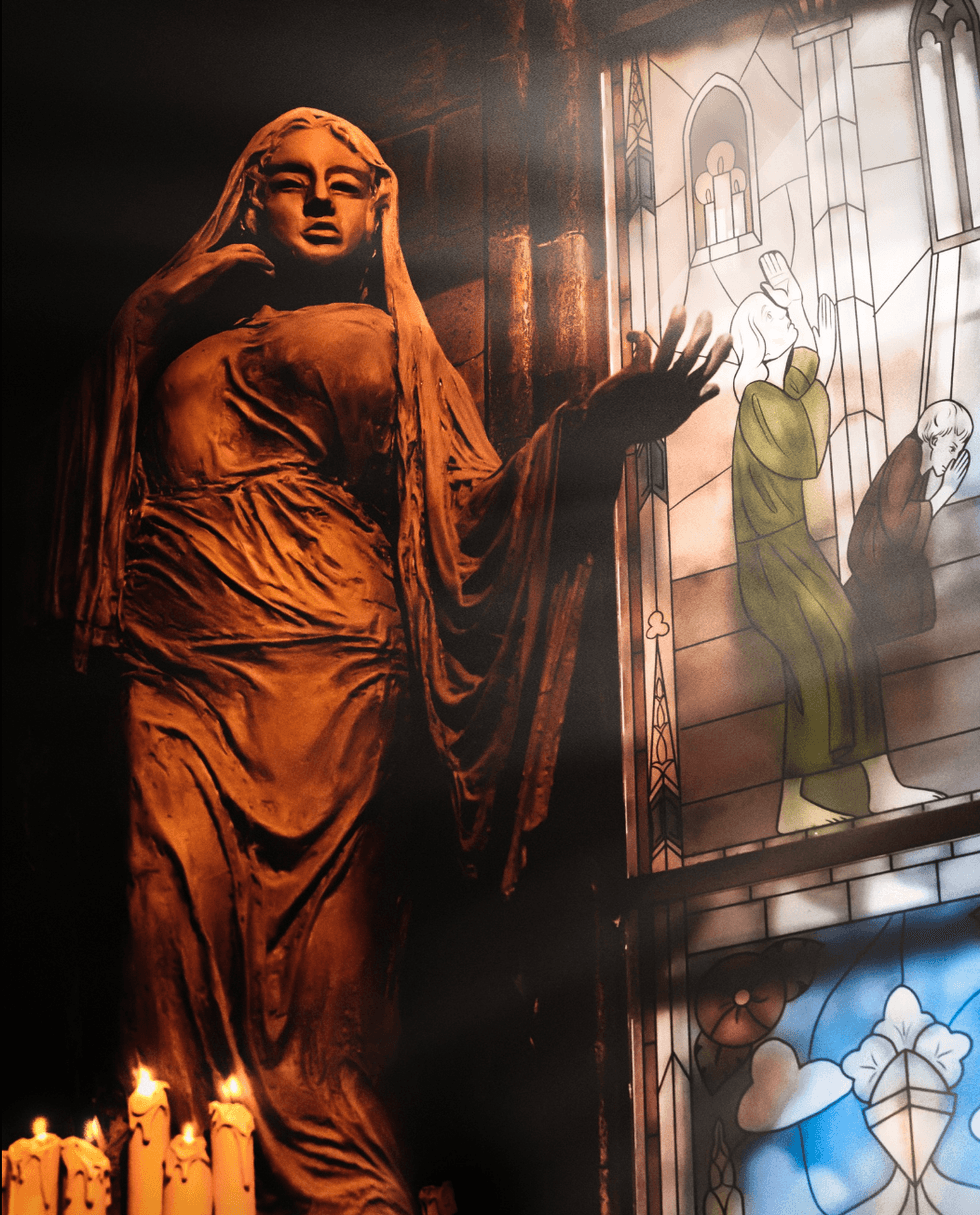 Statue de femme devant un vitrail dans une cath\u00e9drale.
