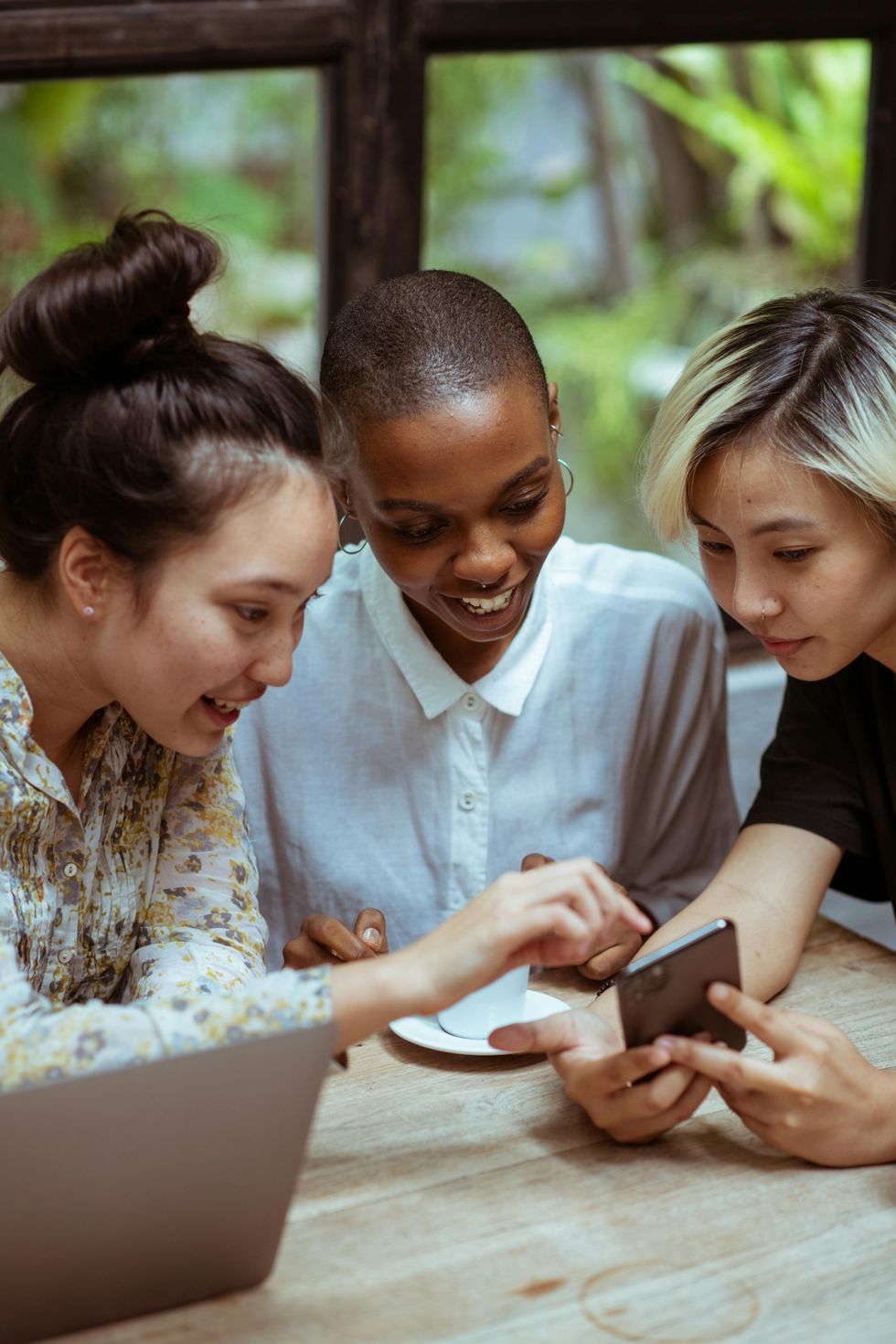 Three people browsing smartphone.