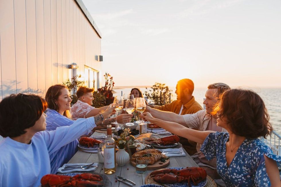 Friends raise their glasses over a lobster dinner in New Brunswick.