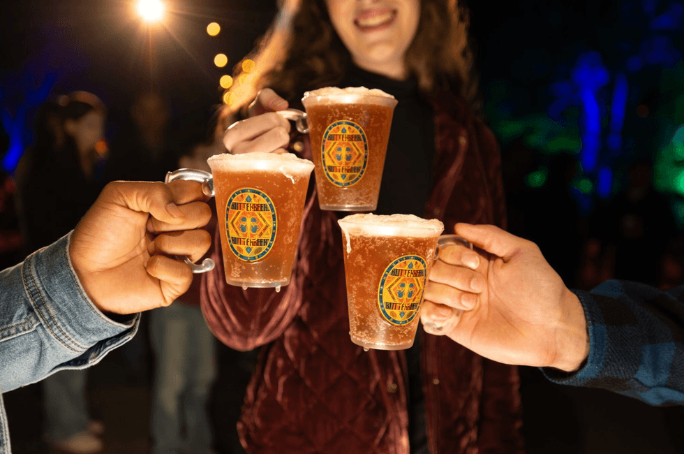 Guests enjoy a themed village at the end of the illuminated trail.