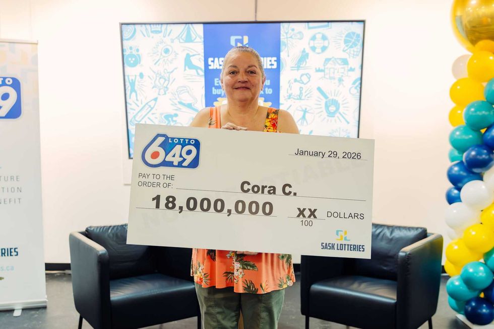 lotto 6/49 winner Cora Cuthbert holding an $18 million cheque