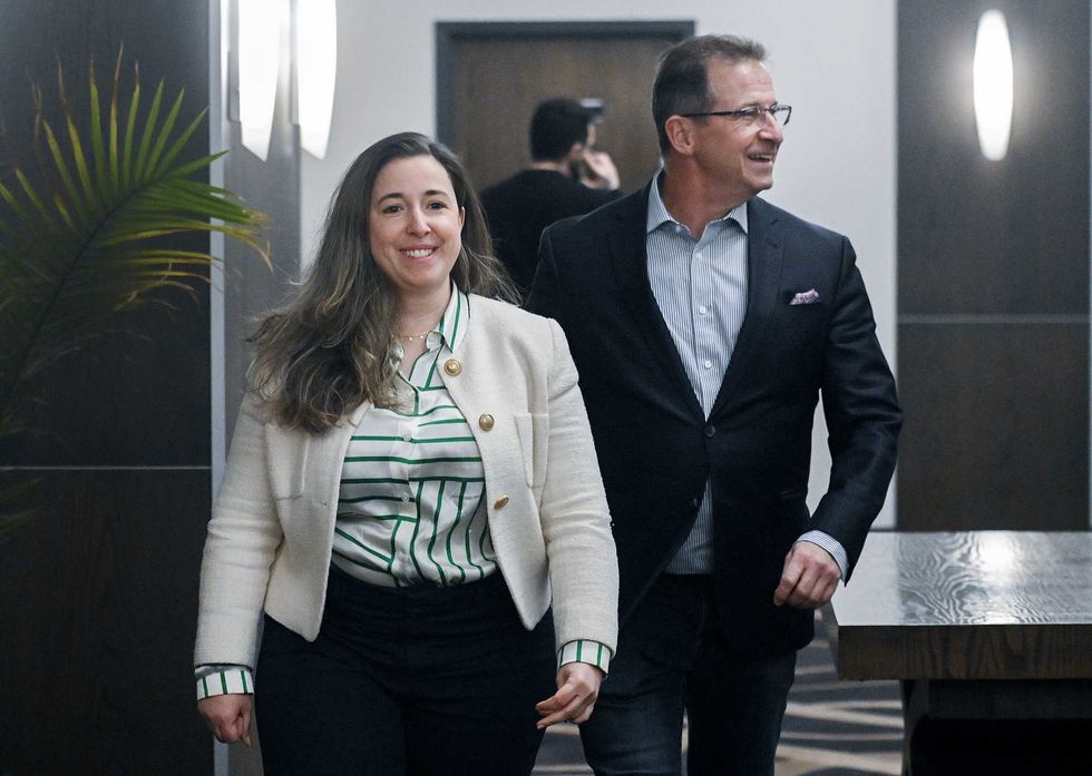 Nathalie Sinclair-Desgagne and Yves-Fran\u00e7ois Blanchet walk down a hall together.