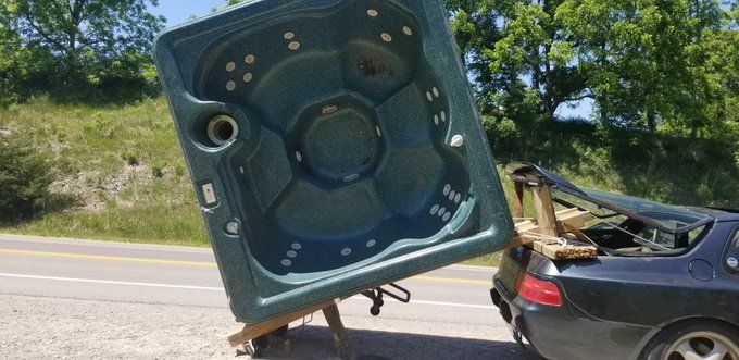 Porsche Pulling A Hot Tub Down The Road Results In An Ontario Man Being Charged