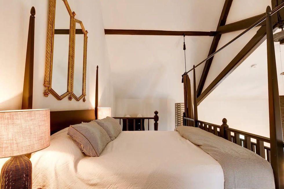 The Ontario Airbnb has a king-sized bed high up in a loft.
