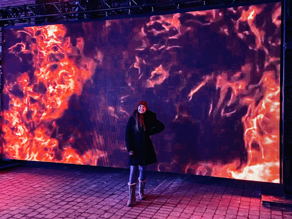 Standing in front of a fire blaze light installation along Bank Street, Ottawa.