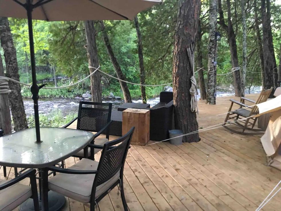 Ourdoor seating areas between trees on Mississipi River private island.