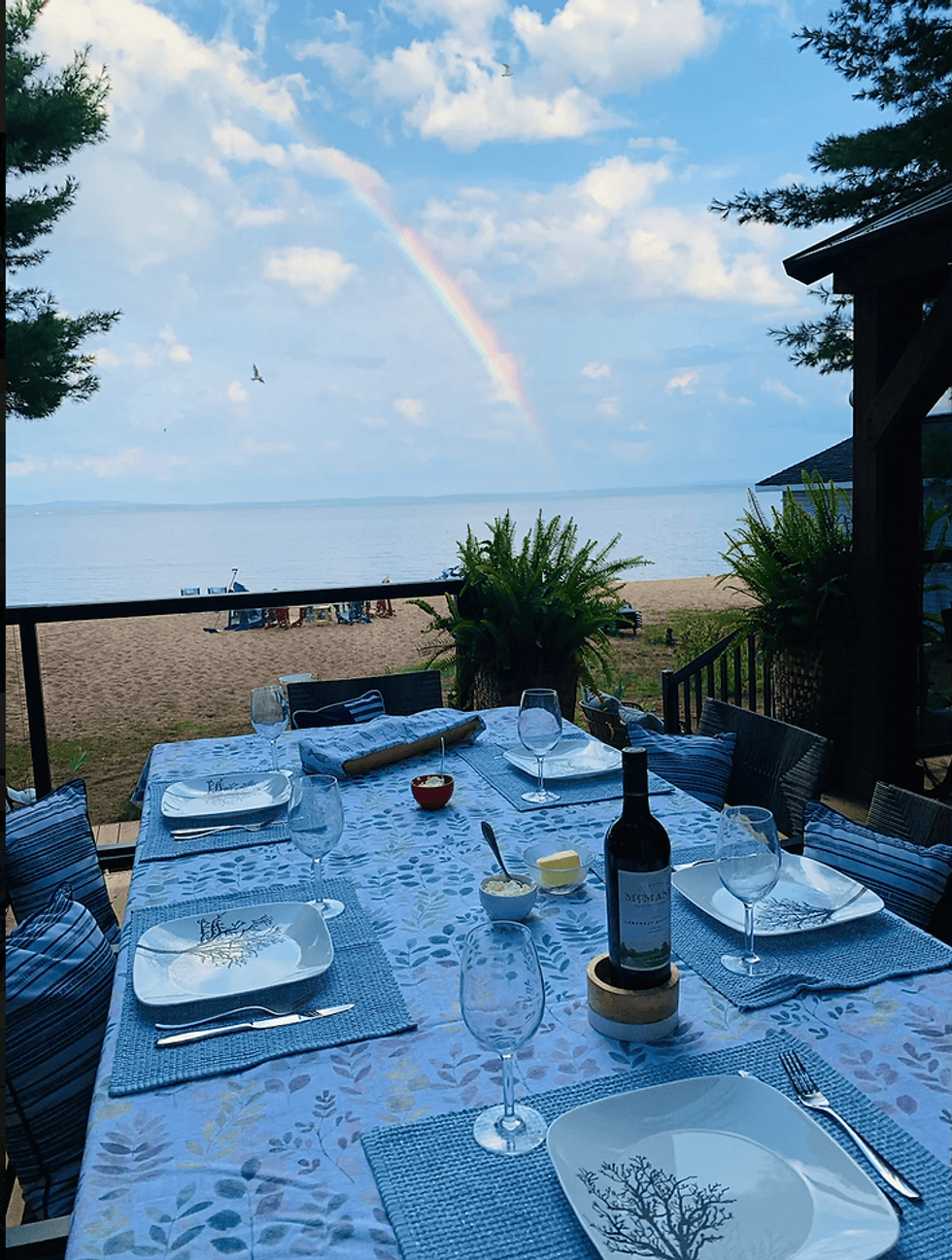 Outside patio dining table with beachfront views over the lake.