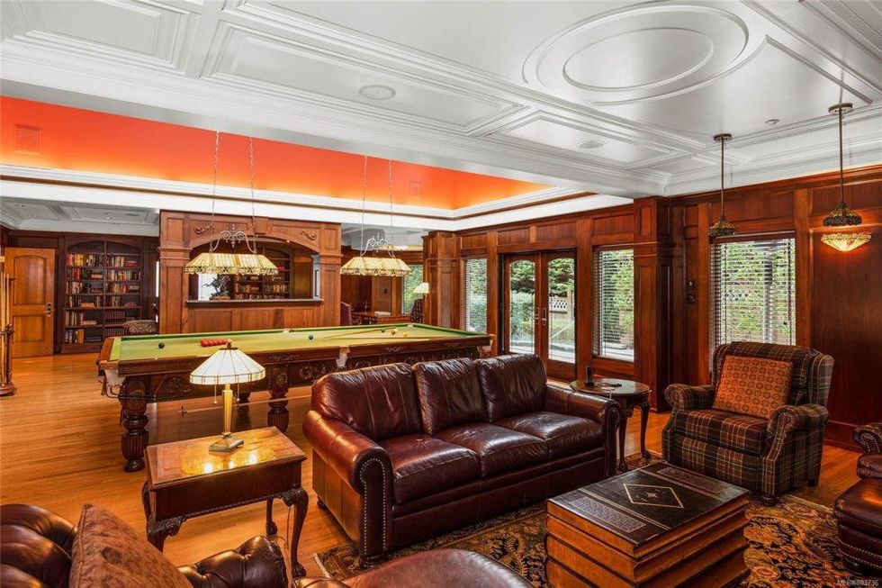 The wood-panelled den with billiards table.