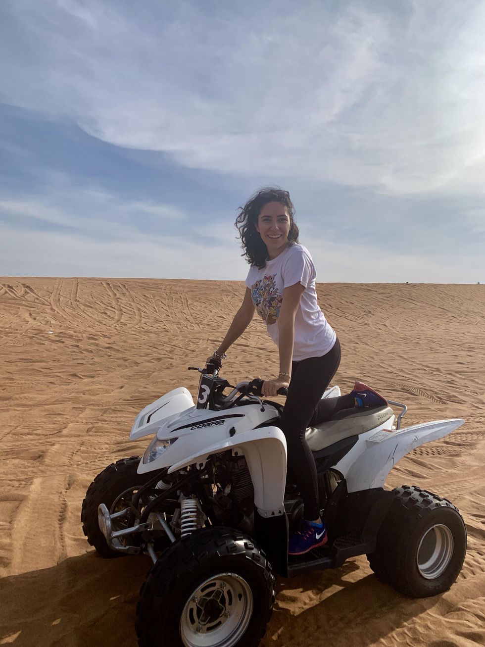 Mira Nabulsi riding a desert ATV in Dubai