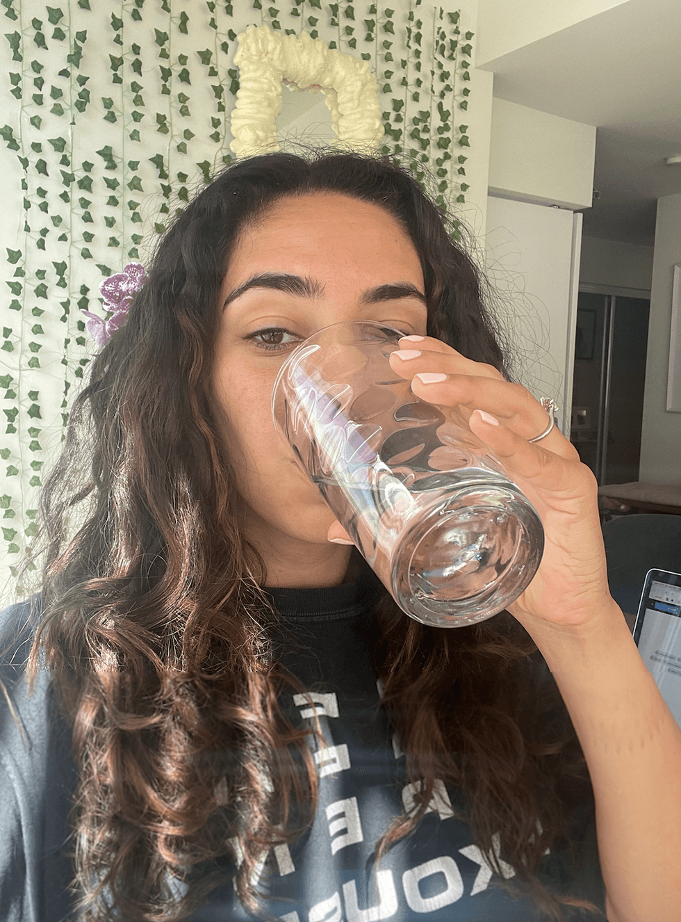 Mira Nabulsi drinking a glass of water in her Toronto apartment.
