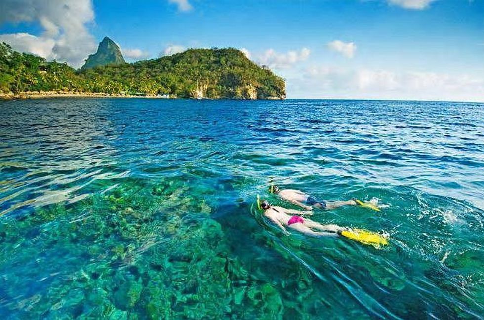 Two adults snorkeling in Saint Lucia.