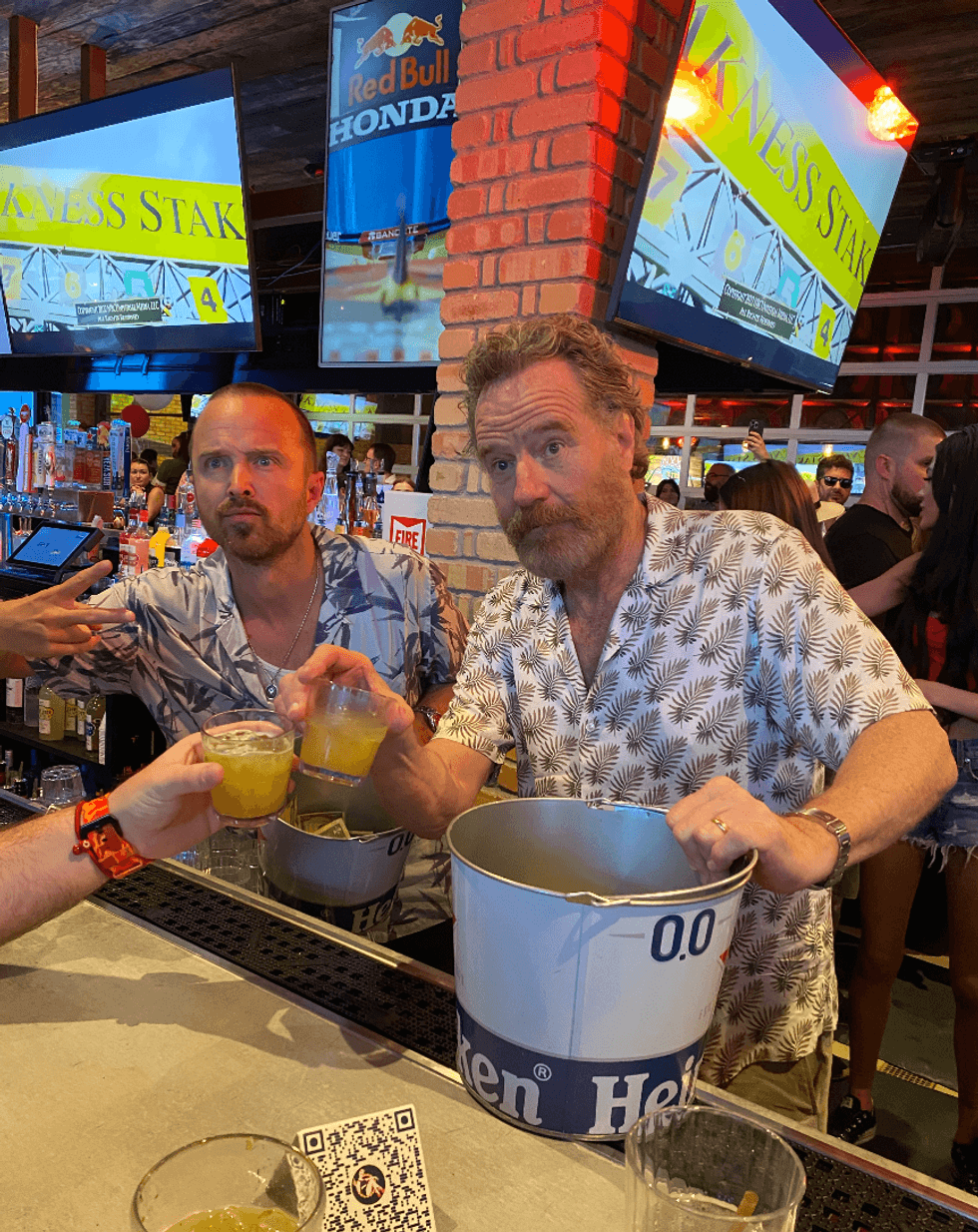 Aaron Paul and Bryan Cranston behind Bottled Blonde Miami's bar.