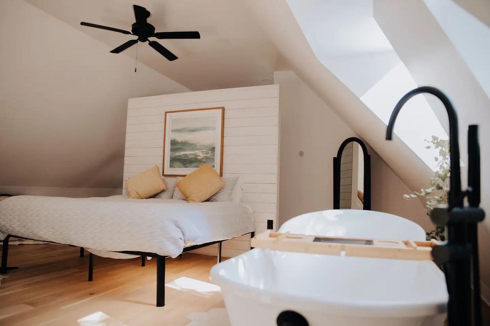 Clawfoot soaker tub and king sized bed in Ontario Airbnb at a winery.