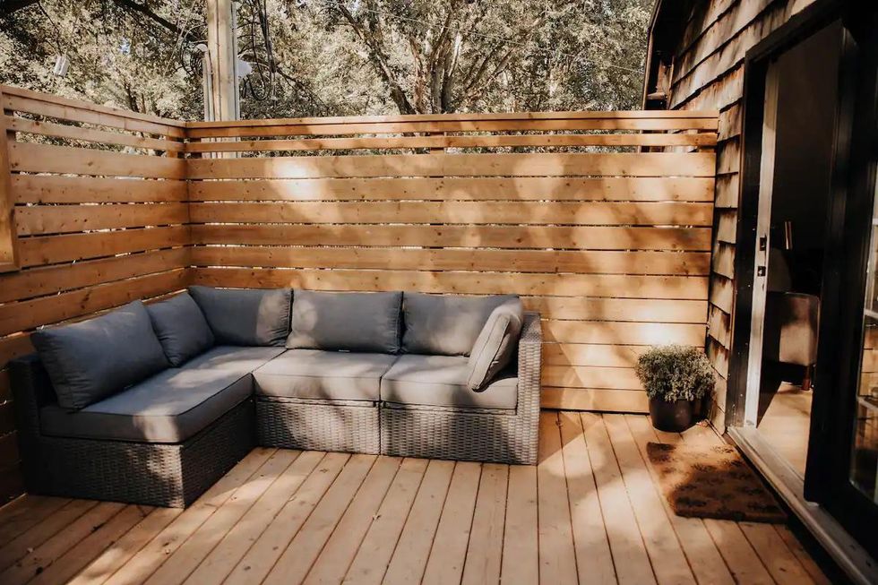 Private outdoor patio with furniture at Ontario farmhouse loft Airbnb.