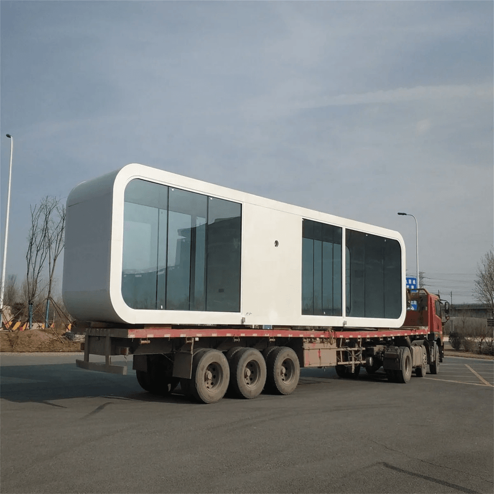 One of the finished container homes being transported on a truck.