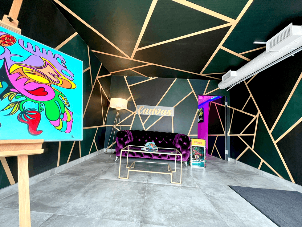 Entranceway with purple couch and artwork.