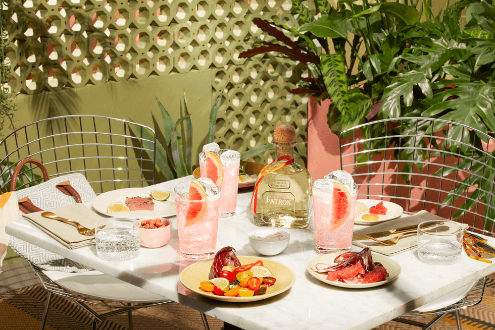 Table with drinks and tropical plants.