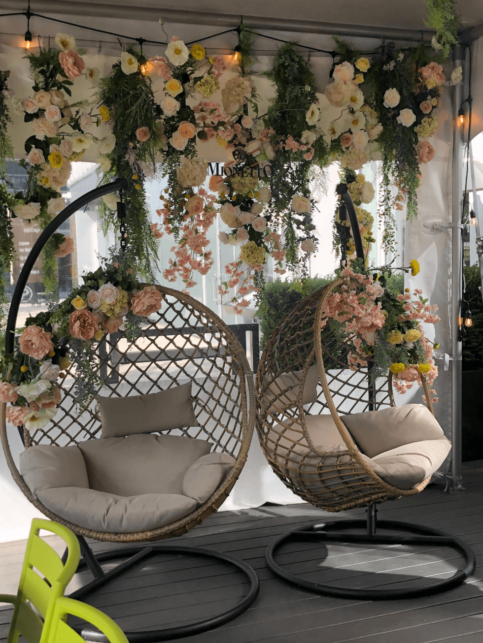 Swinging chairs with flowers.