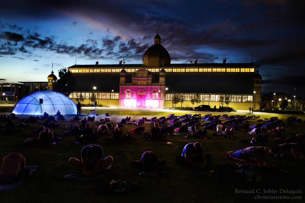 A giant yoga practise at Lansdowne Park during a summer night.