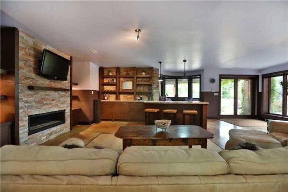Private game room suite with bedroom and kitchenette as part of Airbnb estate.