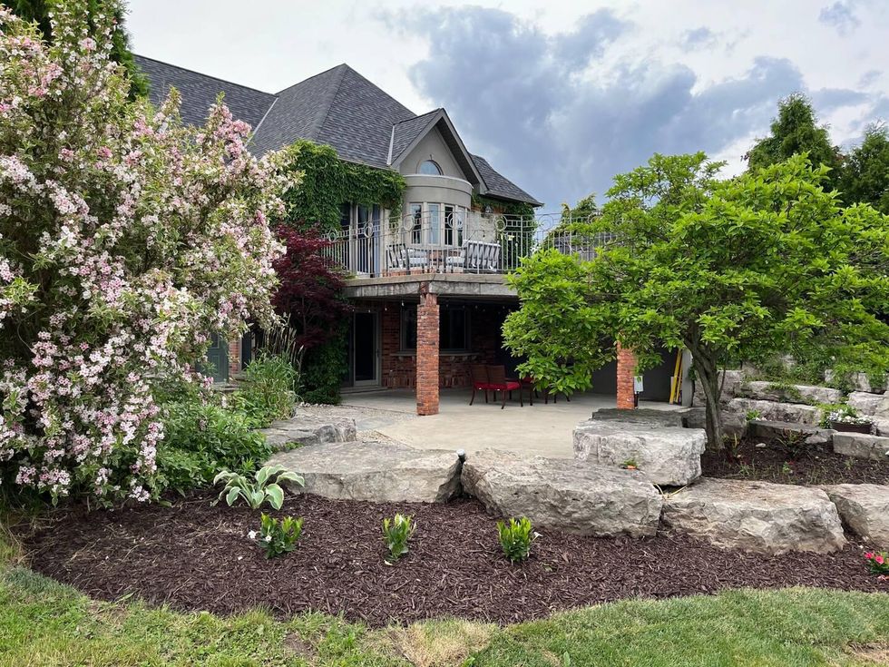 Airbnb backyard two level patio and balcony with beautiful gardens.