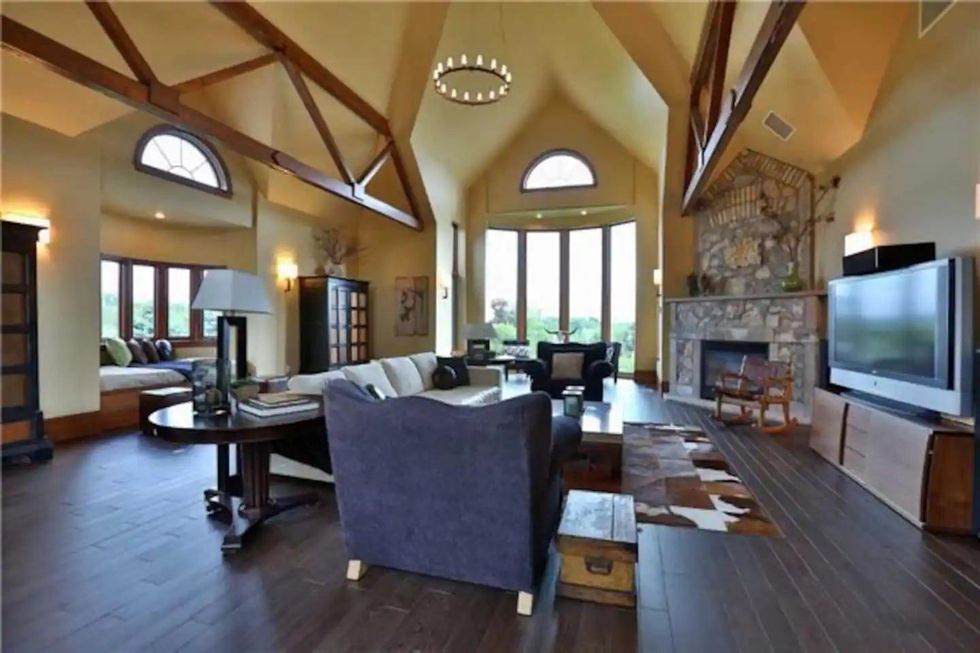 Grand living room with high ceilings and fireplace at Ontario Airbnb.