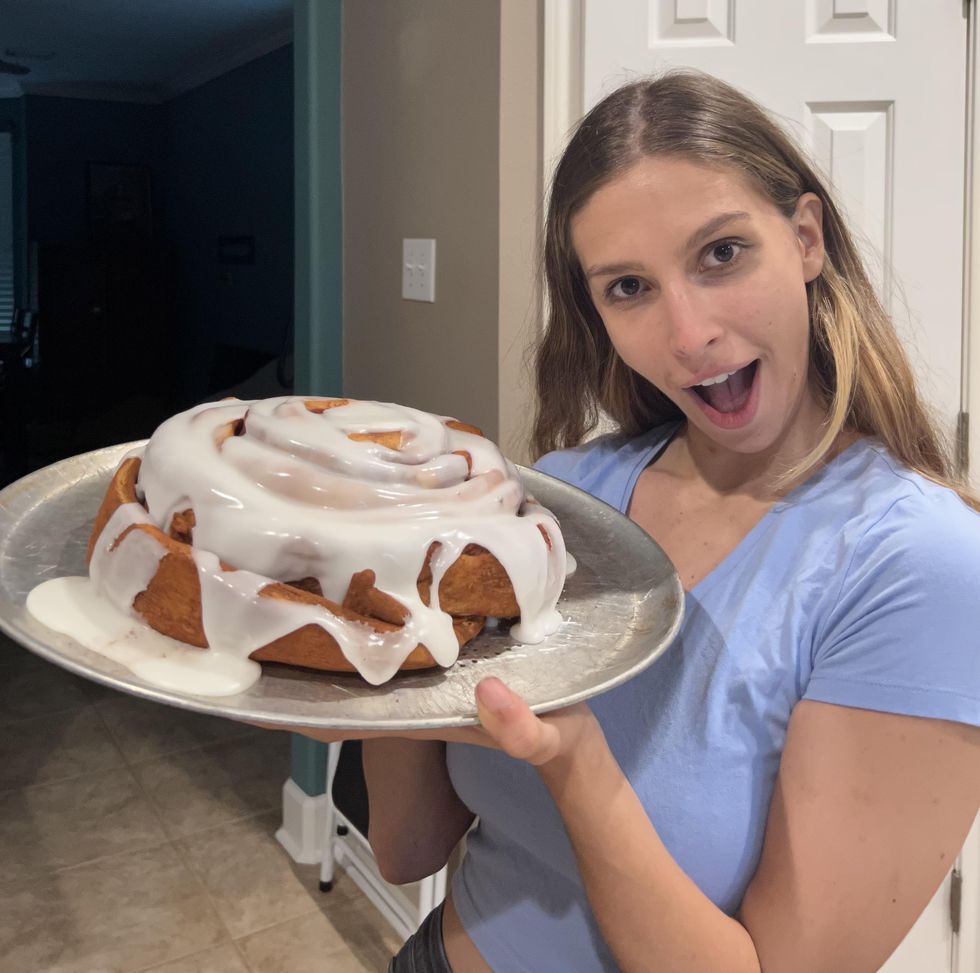 Brittany Cristiano holding the 5-pund cinnamon roll.