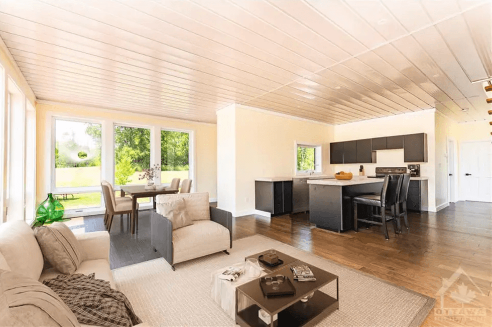 Open-concept area with seating and a kitchen.