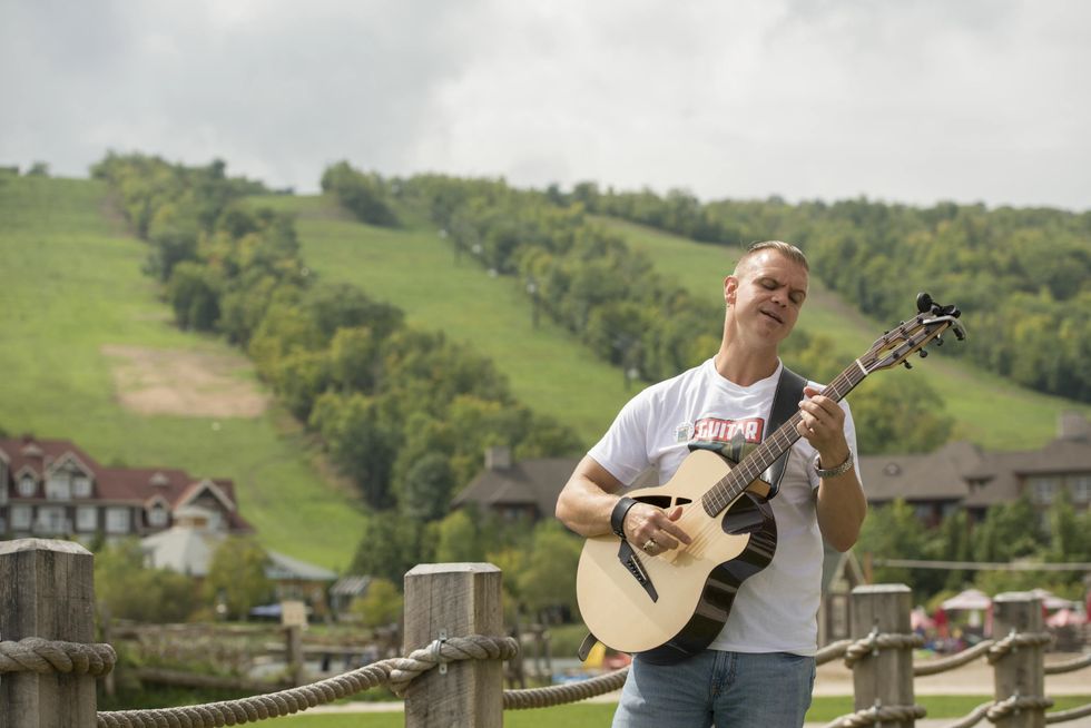 Musician playing on the Guitar Trail in Blue Mountain Resort.