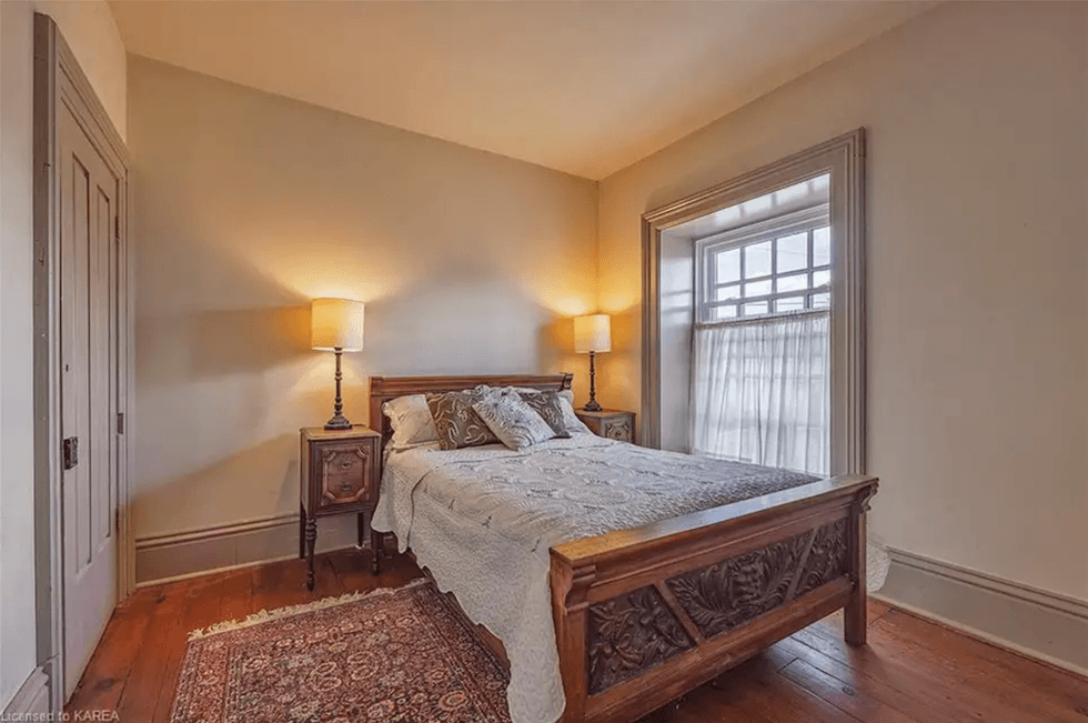 Bedroom with bed and two side tables.