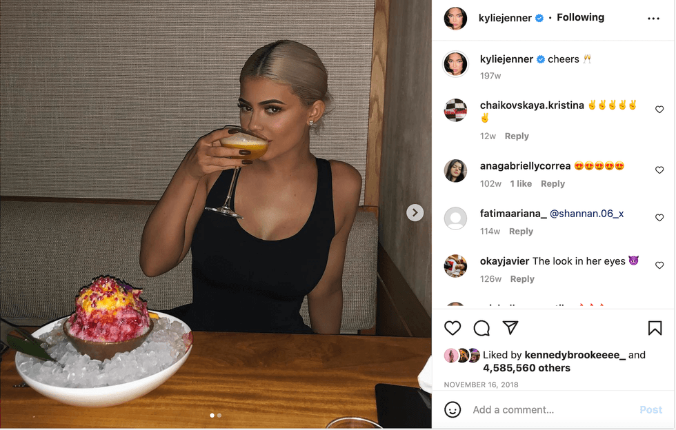 Kylie Jenner drinking a cocktail.