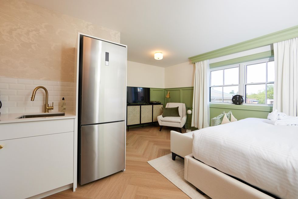 Classic studio hotel room with a kitchenette including a fridge.