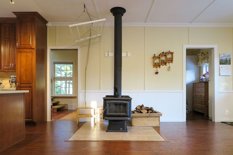 Wood-burning stove in the living space of the house for sale in B.C.