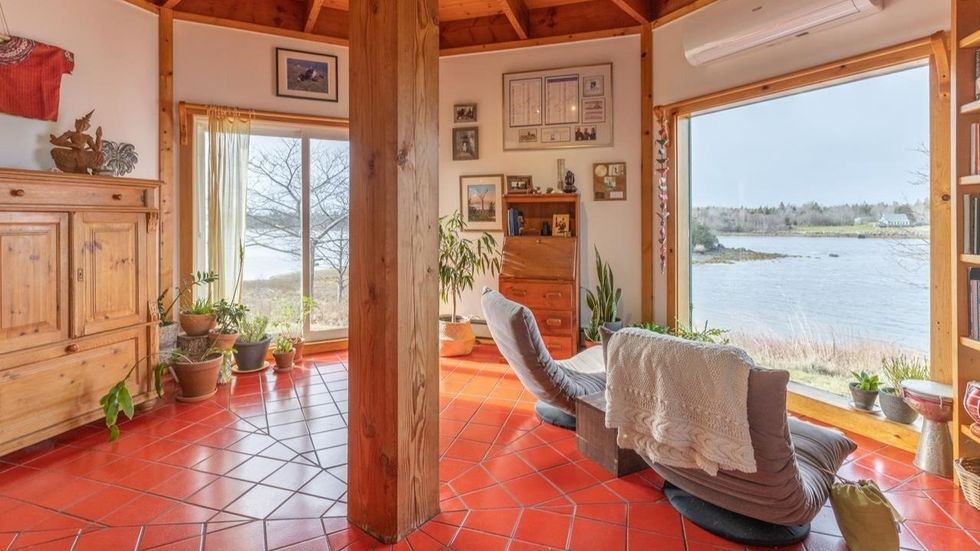 Octagonal den with views of the water and the woods.