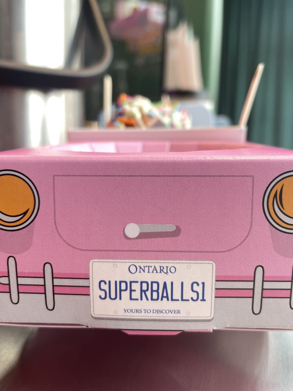 A Superballs Cafe car license plate.