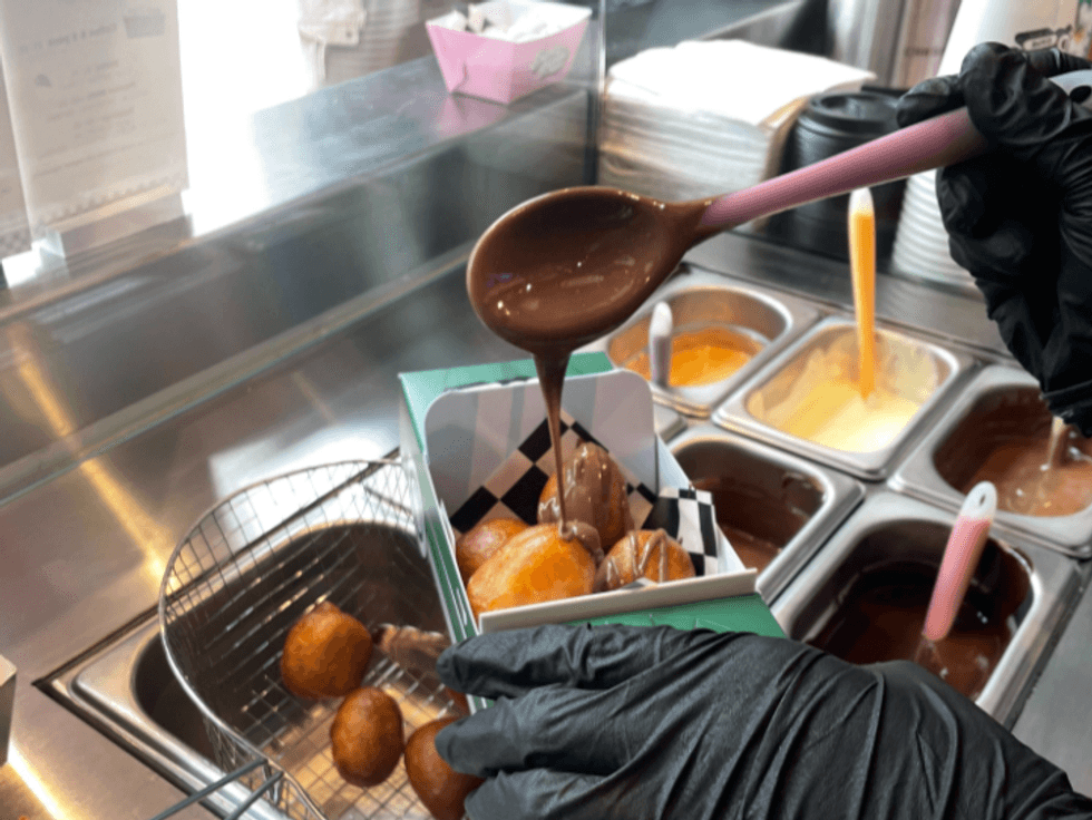A Superballs Cafe employee making an order behind the counter.