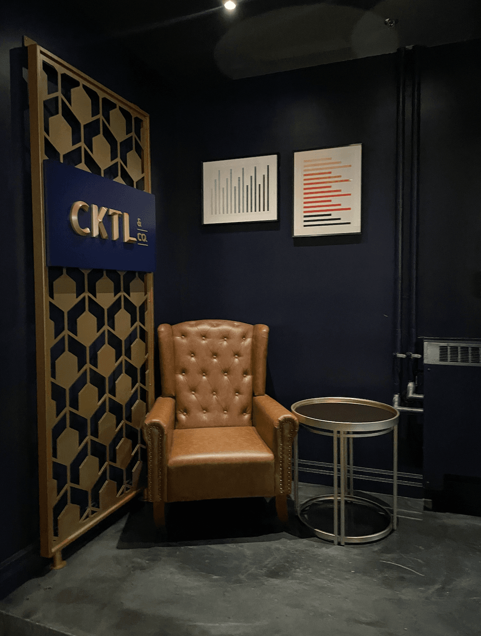 A leather chair and side table in the corner of CKTL.Co.
