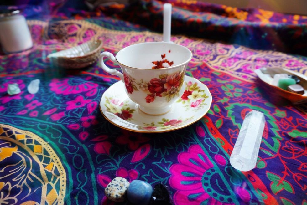 A tea cup filled with tea leaves.