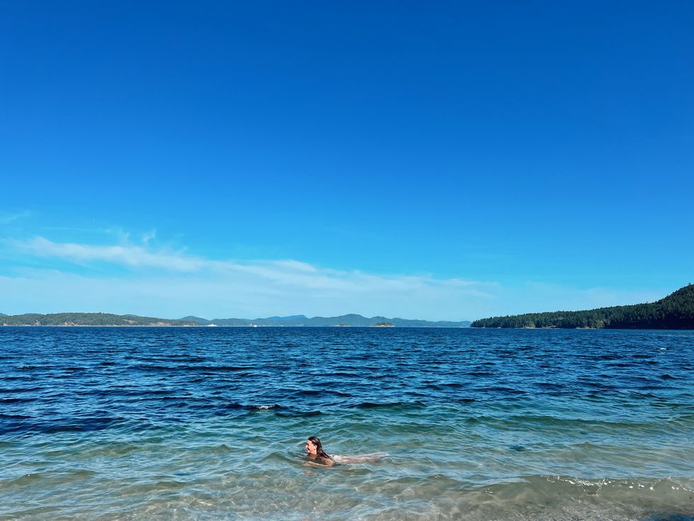 Person swimming at Beddis Beach on Salt Spring Island.