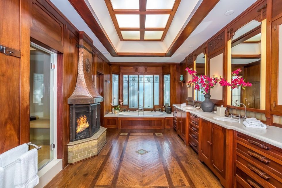 The main suite's bathroom which has a fireplace and a soaker tub.